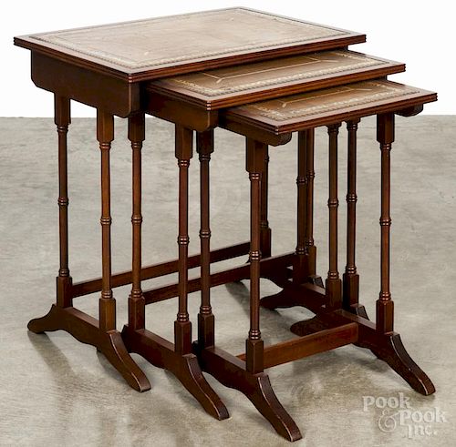 Three mahogany nesting tables with leather inserts, 21 1/2'' h., 20'' w.