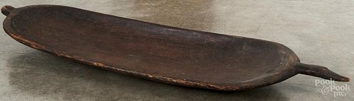 Large wooden trencher, 19th c., with a carved handle, 44'' l.