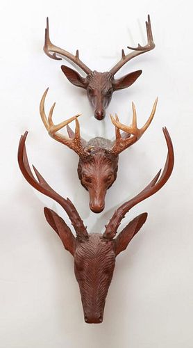 GROUP OF THREE CARVED WOOD STAG TROPHIES