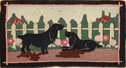 HOOKED RUG WITH A PAIR OF BLACK SPANIELS IN A GARDEN