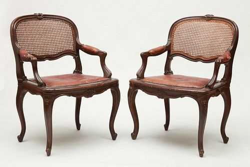 PAIR OF LOUIS XV STYLE STAINED OAK, CARVED AND LEATHER UPHOLSTERED FAUTEUILS EN CABRIOLET