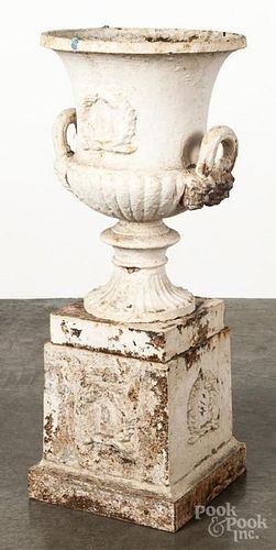 Cast iron garden urn on a pedestal base, 19th c., the base with a foliate wreath, overall - 39'' h.