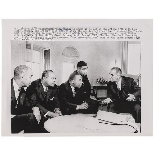 [KING, Martin Luther, Jr. (1929-1968)]. Press photograph of Martin Luther King and fellow leaders with President Lyndon Johnson, discussing his war on