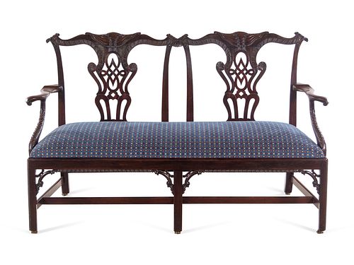 A George III Carved Mahogany Double Chair-Back Settee after a Design by Thomas Chippendale