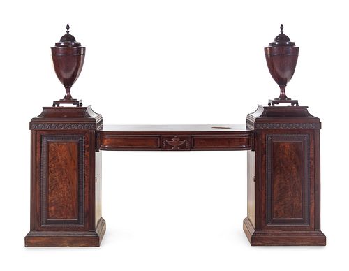 An Edwardian Carved and Figured Mahogany Double Pedestal Sideboard and a Pair of Urn-Form Cutlery Boxes
