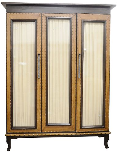 Large Bausman and Company Three-Door Cabinet, having leather and tac, framed glass doors and shelves on interior, height 102 inches, width 78 inches, 
