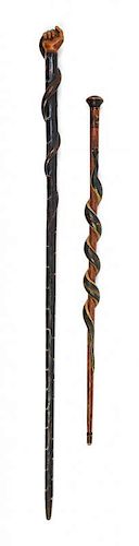 Two Carved and Painted Walking Sticks Length of longest 33 inches.