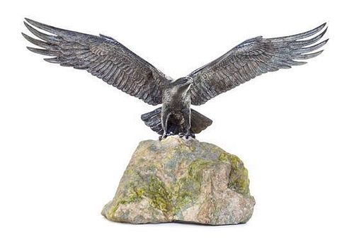 An English Silver Model of an Eagle, Asprey & Co., London, 1977, with spreading wings, on a stone base.