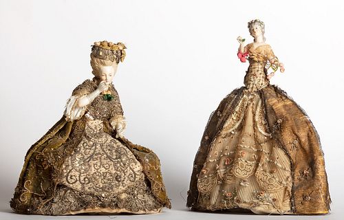 Two dolls with embroidered fabric dresses and porcelain bodies, 19th century