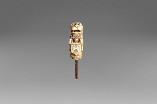 Ancient ivory stick handle depicting a lion with a noble coat of arms