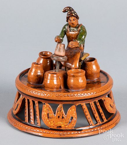 Shooner redware figure of a potter at his wheel