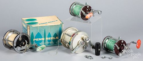 Three Penn fishing reels, and another