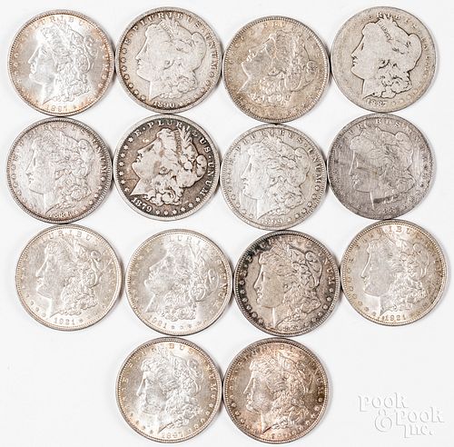Fourteen Morgan silver dollars.