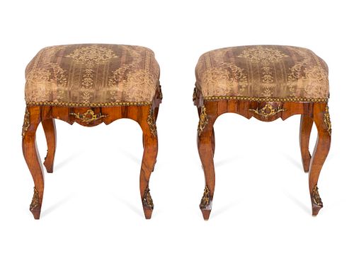 A Pair of Continental Rococo Style Gilt-Metal-Mounted Walnut Tabourets
Height 21 1/2 x length 17 x depth 17 inches.