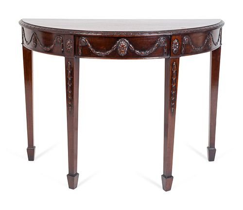 A George III Style Carved Mahogany Demilune Console
Height 31 x width 42 x depth 19 inches.