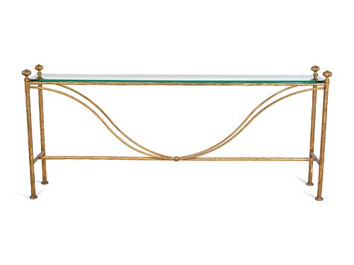 A Neoclassical Style Gilt-Metal and Glass Console
Height 32 x length 71 1/2 x depth 11 inches.