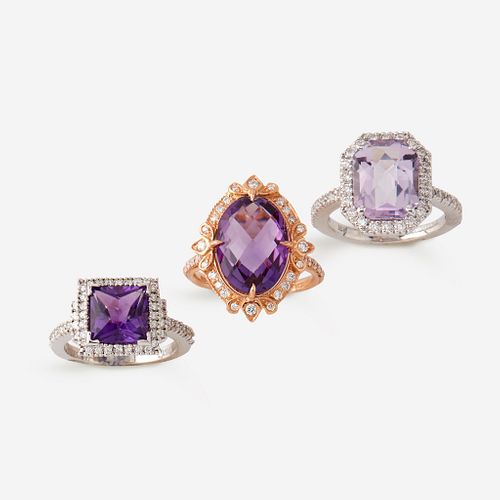 A collection of three amethyst and diamond rings,