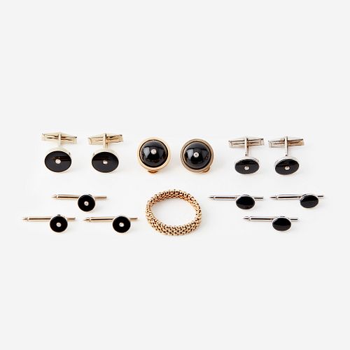 Two onyx, diamond, and fourteen karat gold cufflink and stud sets with matching ear clips and a ring,