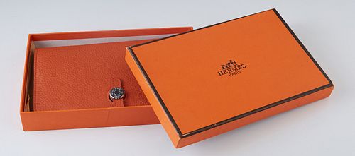 Hermes Orange Togo Leather Dogon Wallet, 2006, with palladium hardware and a slip tab closure, the interior lined with matching orange calf-skin leath