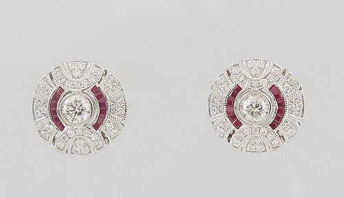 Pair of Circular Platinum Earrings, with a central .32 ct. round diamond within two rows od baguette rubies, and an outer semi-circular border of roun