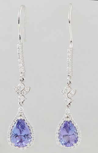 Pair of Platinum Pendant Earrings, with a diamond mounted hook to a diamond mounted floriform link, suspending a pendant with a pear shaped 1.89 ct. t