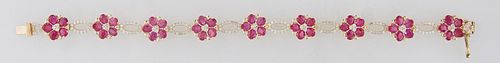 14K Yellow Gold Link Bracelet, the nine floriform links with oval ruby "petals," around a center mounted with three round diamonds, joined by nine ova