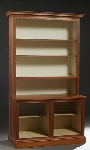 Louisiana Carved Cypress Bookcase, 20th c., the stepped crown over open shelves, flanked by beaded board sides, on a base with open storage and beaded