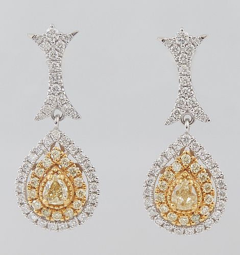 Pair of 18K White Gold Pendant Earrings, the diamond mounted screwback stud, to a long link and a pendant with a pear shaped yellow diamond atop a bor