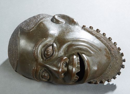 African Patinated Bronze Head of a Man, 20th c., H.- 5 in., W.- 7 in., D.- 10 3/4 in.
