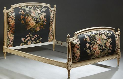 French Louis XVI Style Polychromed Beech Double Bed, 20th c., the arched upholstered cushioned headboard on turned tapering reeded supports with pinea