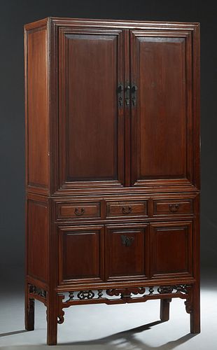 Chinese Carved Elm Qing Dynasty Cabinet, 19th c., with large double doors over three frieze drawers, above a central fall front cabinet, on reeded blo