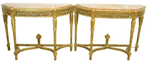 Pair of Gilt Demilune Tables, with rouge marble tops with pierce carved friezes, set on carved and fluted legs, with urn finials, (marbles professiona