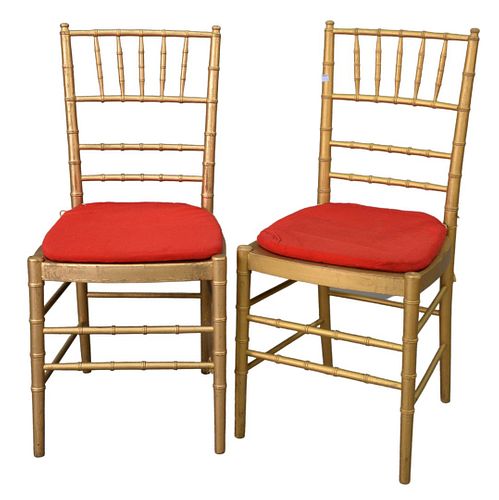 Set of Ten Faux Bamboo Chairs, gold with red slip seats, seat height 17 1/2 inches, total height 36 inches.