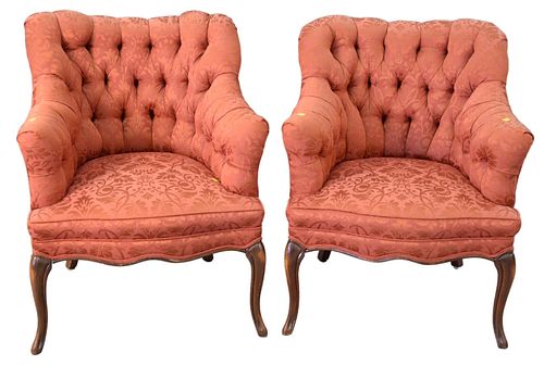 Pair of French style club chairs, having red upholstery with tufted back.