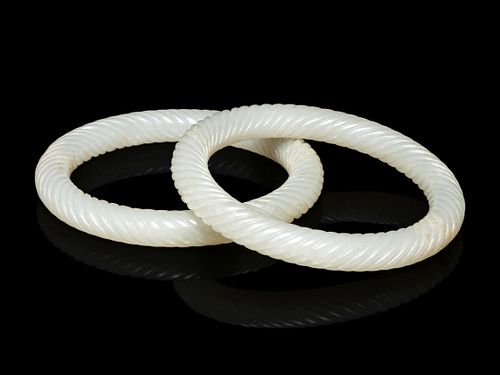 A Pair of White Jade 'Twisted Rope' Bangles