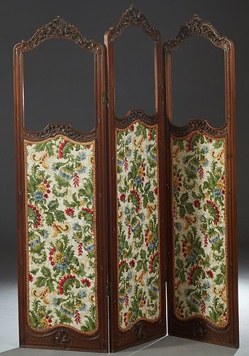 Louis XV Style Carved Walnut Three Panel Dressing Screen, late 19th c., each arched panel with a C-scroll and floral carved crest over a previously gl