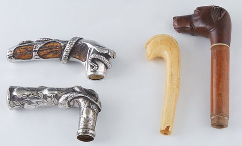 Group of Four Cane or Umbrella Handles, early 20th c., one of antler mounted with a coiled sterling snake; one sterling with relief floral decoration;