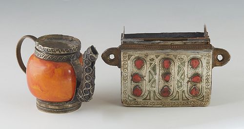 Two Moroccan Pieces, 20th c., consisting of a stamped metal Qur'an holder pendant, with incised decoration, one side mounted with 9 red stones, design