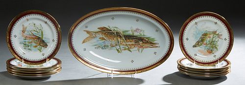 French Limoges Thirteen Piece Porcelain Fish Set, early 20th c., consisting of 12 circular plates and a long oval platter, early 20th c., with gilt ri