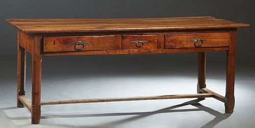 French Provincial Carved Cherry Farmhouse Table, early 19th c., the five board top over a wide skirt with three frieze drawers on one long side, on ch