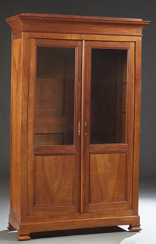 French Louis Philippe Carved Cherry Bookcase, 19th c., the stepped edge top over double doors with glazed upper panels over wood lower panels, on a pl