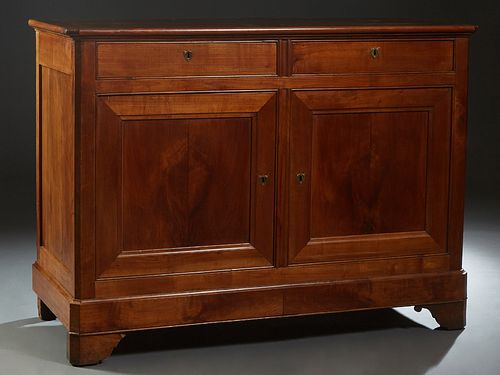 French Provincial Louis Philippe Carved Cherry Sideboard, c. 1860, the canted corner top over two frieze drawers above double cupboard doors, on a ste
