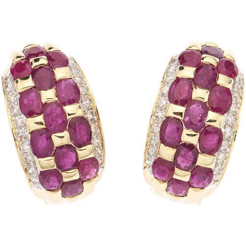 PAIR OF EARRINGS WITH RUBIES AN DIAMONDS IN 14K YELLOW GOLD 26 Oval cut rubies ~3.90 ct, 40 Brilliant cut diamonds ~0.57 ct