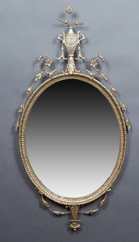 French Style Silvered Wood and Iron Overmantel Mirror, 20th c., with an urn and floral surmount above a wide beveled oval plate, H.- 50 1/2 in., W.- 2