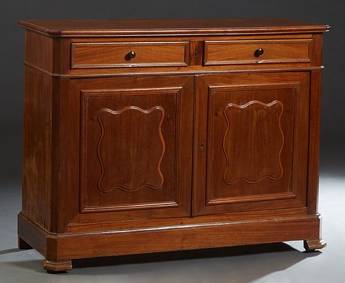 French Provincial Louis Philippe Carved Walnut Sideboard, 19th c., the rounded edge canted corner top over two frieze drawers, and double fielded pane