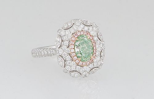 Lady's 18K White Gold Dinner Ring, with an oval 1.06 ct. green diamond, atop a border of pink diamonds, and an outer pierced scalloped border of round