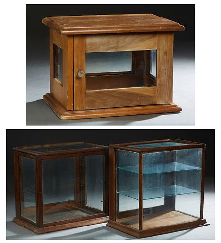 Group of Three Tabletop Display Cases, early 20th c., one of pine with four glazed sides; one of oak with a glazed top and sides; and one of oak with 