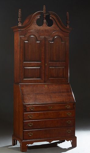 American Georgian Style Carved Mahogany Breakfront Secretary Bookcase, 20th c., by the Wright Furniture Co., the broken arch pediment with three corks