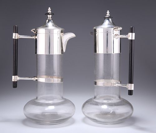 A NEAR PAIR OF SILVER-PLATE MOUNTED CLARET JUGS, IN THE MAN