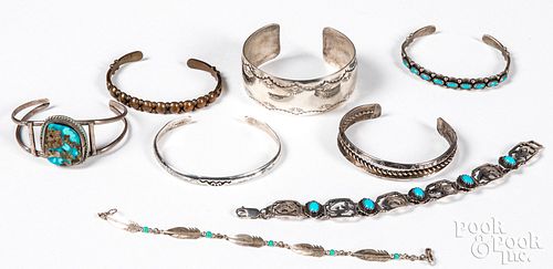 Eight Native American silver and copper bracelets